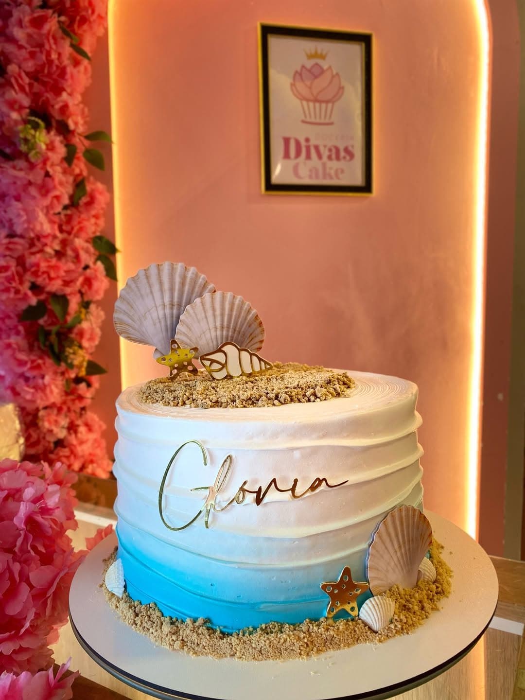 Bolo personalizado da Divas Cake, decorado com conchas e areia de biscoito